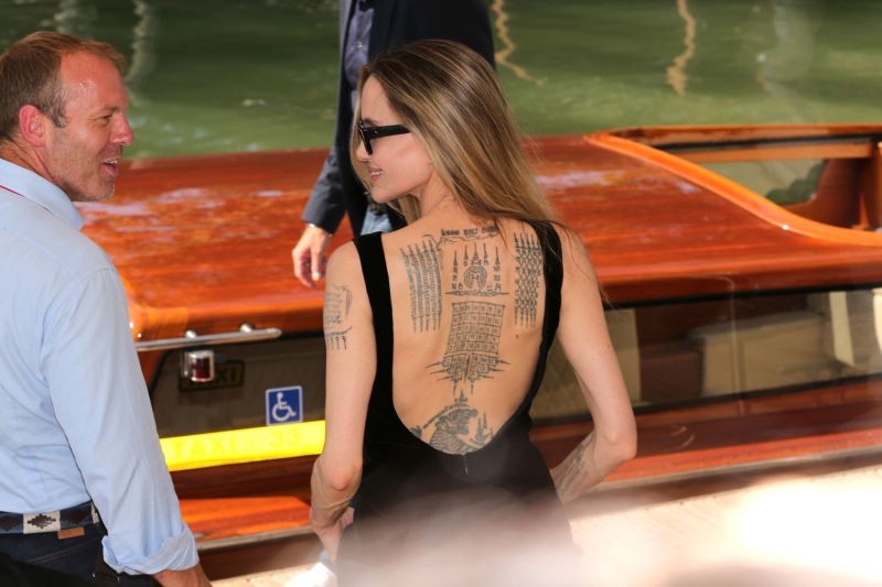 Angelina Jolie wore a backless LBD that showed off her tattoos at the 81st Venice Film Festival on Thursday (August 29).