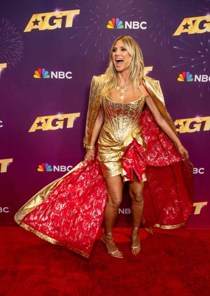 Heidi Klum wore a metallic gold corset mini dress to the quarterfinals of America's Got Talent.' The look was designed by Christian Siriano.