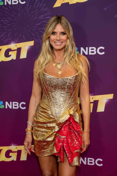 Heidi Klum wore a metallic gold corset mini dress to the quarterfinals of America's Got Talent.' The look was designed by Christian Siriano.