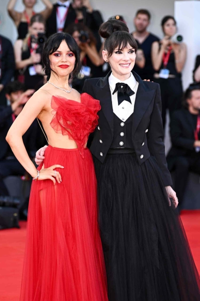 Jenna Ortega and Winona Ryder wore matching 'Beetlejuice'-themed looks to the red carpet premiere of 'Beetlejuice Beetlejuice' at the 81st annual Venice Film Festival. See their outfits, here.