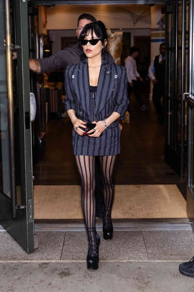 Jenna Ortega wore a Vivienne Westwood suit with a sheer corset and sky-high platform boots. See her spooky-sexy 'Beetlejuice'-inspired look, here.