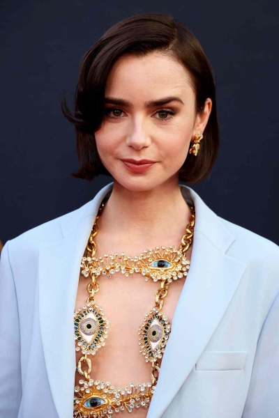 Lily Collins wore a peplum gown with her chic bob on the red carpet at the season premiere of 'Emily in Paris' season 4. See her full look, here.