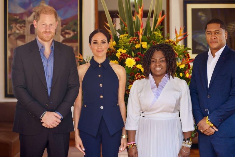 Meghan Markle wore a pink midi dress with a bust cutout and high leg slit for a day at Bogotá's National Center for the Arts with Prince Harry. See her flirty look, here.