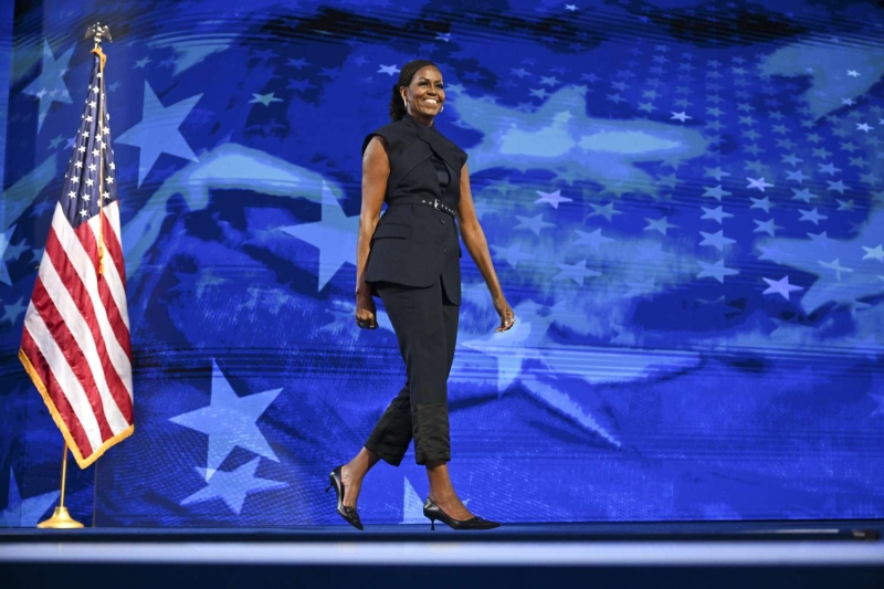 Michelle Obama stepped out at the Democratic National Convention on August 20 wearing an unconventional sleeveless suit from Monse, a waist-length bohemian braid, and divisive shoes. See the look.