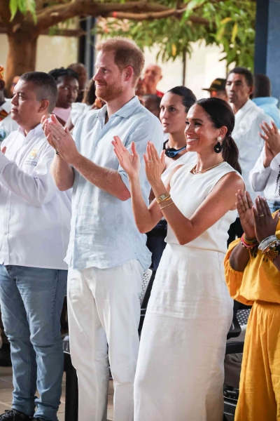 On day three of her and Prince Harry's Colombian tour, Meghan Markle wore a white linen maxi skirt with a matching tank top and sunhat. See her full look, here.