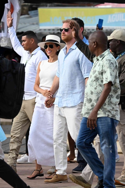 On day three of her and Prince Harry's Colombian tour, Meghan Markle wore a white linen maxi skirt with a matching tank top and sunhat. See her full look, here.