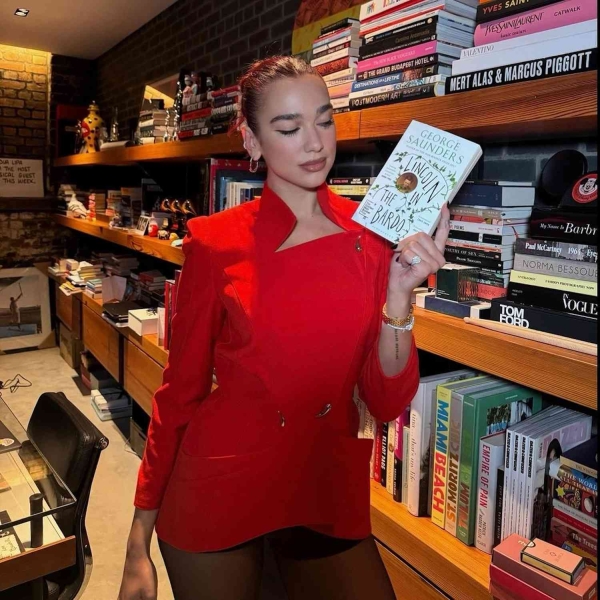 Dua Lipa shared her latest book club pick for Service95 with an Instagram post showing her wearing a vintage Mugler jacket and no pants. See more, here.