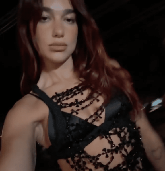 Dua Lipa wore a black beaded top with a satin bra in a post shared to her Instagram. See the look, here.