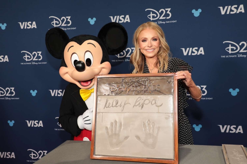 During today's episode of 'Live with Kelly and Mark,' Kelly Ripa explained that her daughter, Lola Consuelos, wore one of her dresses to this year's D23 event. See more, here.