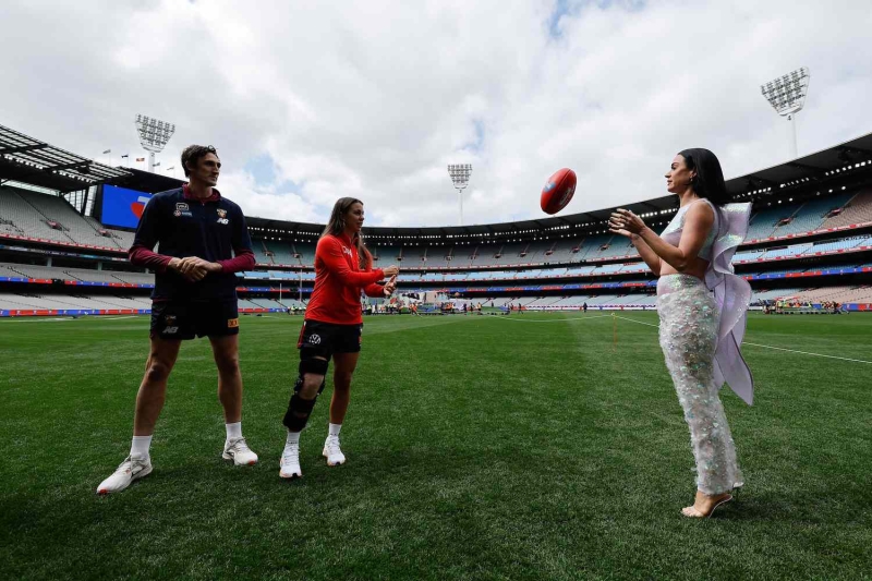 Katy Perry made an appearance ahead of her AFL Grand Final performance this weekend in Australia wearing a long skirt and crop top with shimmering wings. See the full look, here.