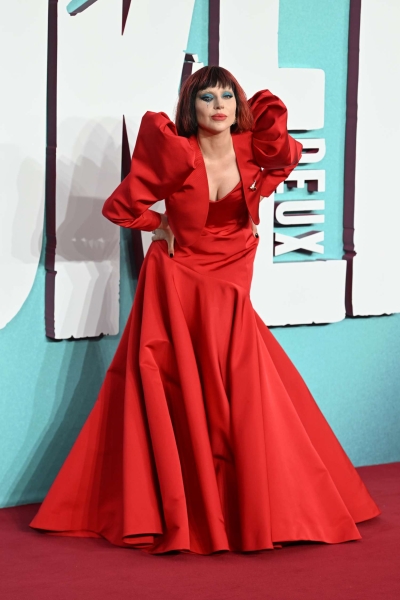 Lady Gaga paid homage to her song 'Bad Romance' in a red gown with structured shoulders and black-and-maroon blunt bob for the U.K. premiere of 'Joker Folie à Deux.'