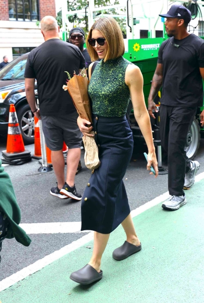 Look of the Day for September 18, 2024 features Jessica Biel in a front-button skirt, mock-neck tank top, and water-resistant clog slip-ons while out and about in New York City.