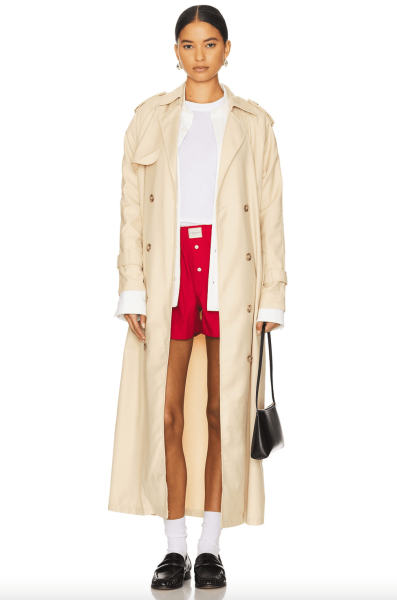 Look of the Day for September 30, 2024 features Lily Gladstone in a knit dress and trench coat during Paris Fashion Week.