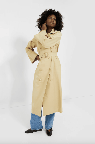 Look of the Day for September 30, 2024 features Lily Gladstone in a knit dress and trench coat during Paris Fashion Week.