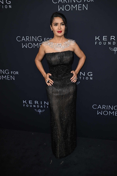 Salma Hayek wore a sculptural statement necklace with a strapless naked dress at the Kering Foundation's Caring for Women dinner. See her full look, here.