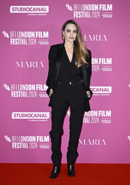 Angelina Jolie paired an all-black suit with the perfect fall boots at the 68th BFI London Film Festival. See her glam businesswear look, here.