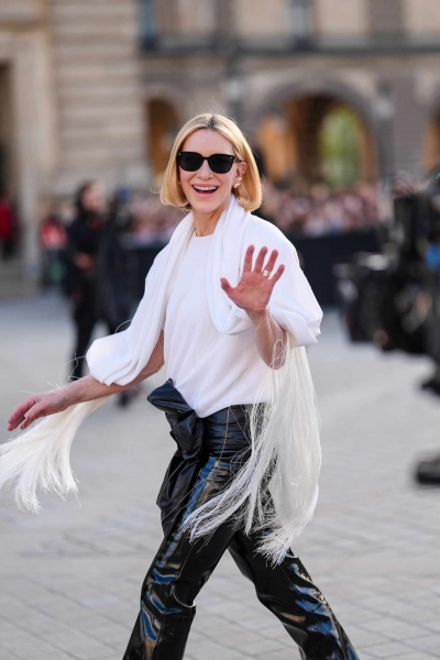 Cate Blanchett wore a boxy white top with a built-in fringed scarf to the Louis Vuitton fashion show in Paris. See her quirky look, here.