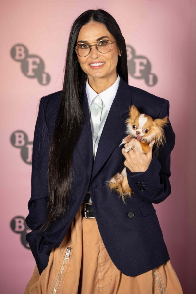 Demi Moore wore a preppy blazer, and tan parachute pants, an outfit that matched the coloring of her dog, Pilaf, perfectly.