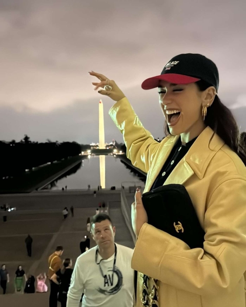 Dua Lipa documented a recent trip to Washington, D.C., during which she wore a butter-yellow leather trench coat. See her look, here.