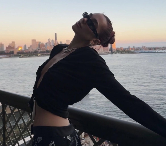 Dua Lipa posted a collection of Instagram images of her donning a long-sleeve black top that was completely split down the middle and held together by a futuristic-looking lock. See the sultry top, here.