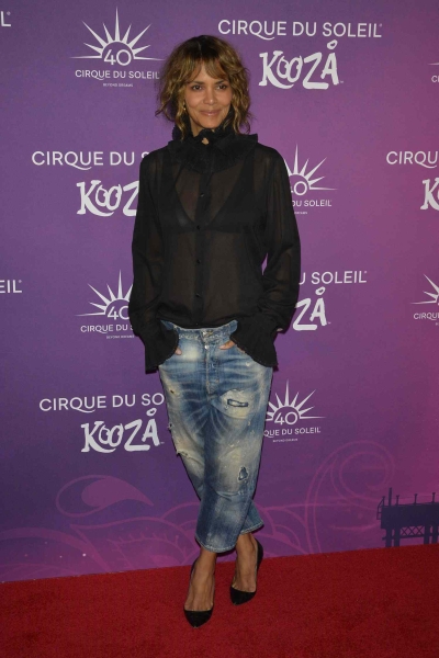 Halle Berry attended Cirque du Soleil's KOOZA premiere in Los Angeles while wearing a sheer top and a pair of divisive jeans on the red carpet. See her full outfit, here.