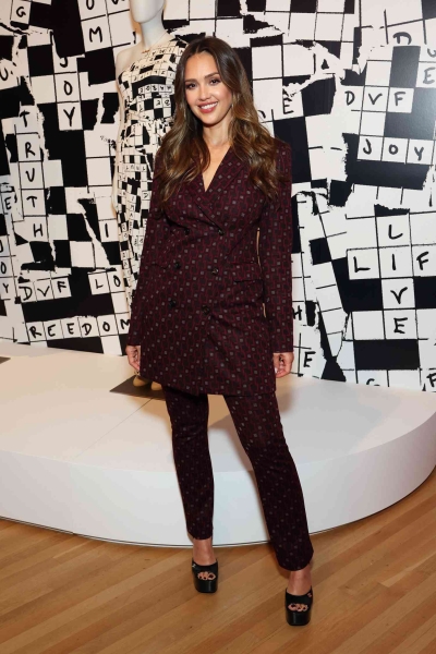 Jessica Alba wore an effortlessly chic slouchy camel cardigan with baggy jeans before changing into a divisive Y2K fashion combo for the "Diane von Furstenberg: Woman Before Fashion" exhibit in Los Angeles on Tuesday, October 15.