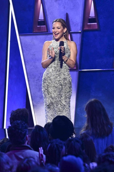 Kate Hudson attended the American Music Awards 50th Anniversary Special in Los Angeles on Sunday, wearing a fuzzy sage green gown that people are comparing to a shaggy bathroom carpet. See her full look, here.