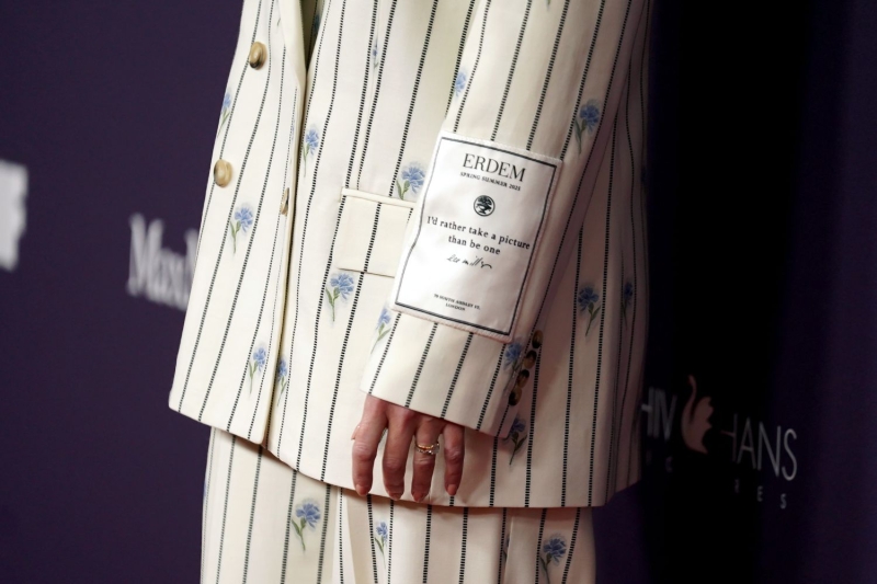 Kate Winslet stepped out at the Women In Film gala wearing a floral pinstripe suit with an unexpected message written on her sleeve.