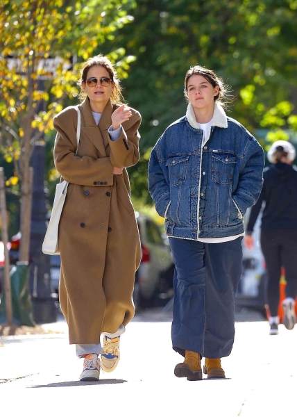 Katie Holmes and her lookalike daughter Suri Cruise stepped out together in New York City, wearing two very different takes on the fall jacket. See their outfits, here.