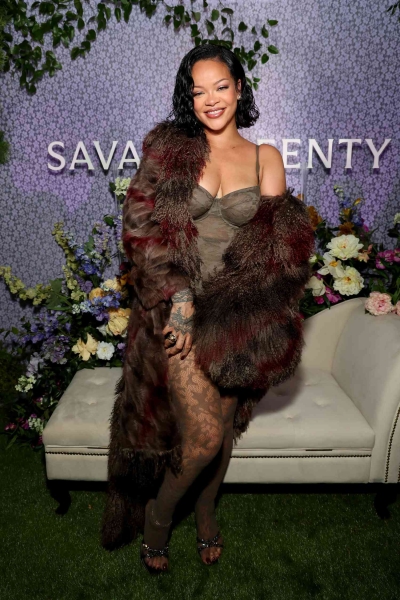 Rihanna looked like she was taking style inspiration from the 2000s wearing a Y2K-inspired corseted camo lace mini dress with matching sheer tights at the Savage X Fenty Lavish Lace collection launch on October 10.