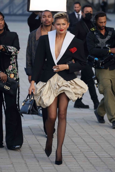 Zendaya touched down for Louis Vuitton's Spring/Summer 2025 show at Paris Fashion Week in a voluminous bubble skirt and dramatic blazer. See her daring look, here.