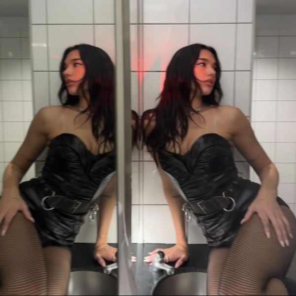 Dua Lipa showed off perpetual summer vibes as she posed in a micro neon string bikini during her Bangkok Radical Optimism tour stop in an Instagram photo dump shared on November 28.