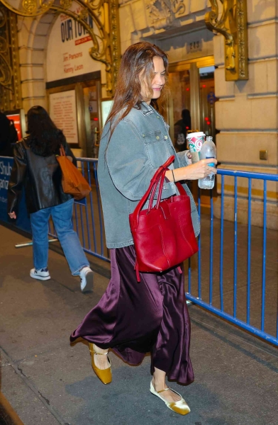 Katie Holmes wore a light wash denim jacket with festive jewel tones on Tuesday, November 19, stepping out in an eggplant skirt and mustard yellow Mary Janes. See the look, here.