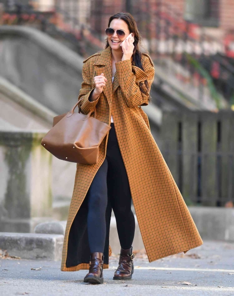 Katie Holmes wore a mustard yellow-and-brown plaid jacket with black leggings and chunky brown boots while out in New York City. See the photos, here.