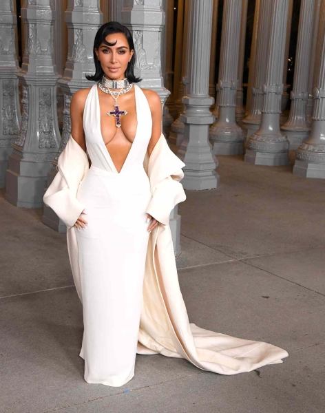 Kim Kardashian wore Princess Diana's "Attallah Cross" necklace with a plunging white gown at the 2024 LACMA Art + Film Gala. See her full look, here.