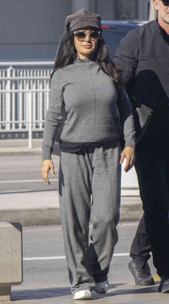 Look of the Day for November 19, 2024 features Salma Hayek in an all-gray lounge set that includes a knit sweater and matching pants. Shop similar two-pieces perfect for fall from Free People, Aritzia, and Gap.