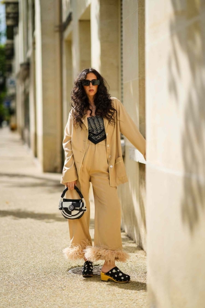 Satin pajama sets have become a street style staple and we've got fresh ways to wear them. Here's how to wear a satin pajama set outside of the house for date night, brunch, and everything in between.