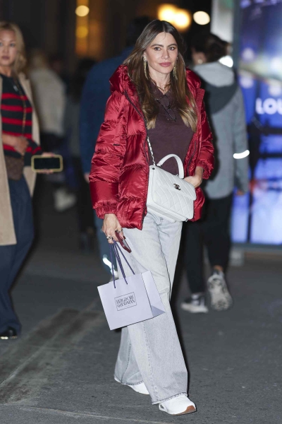 Sofía Vergara embraced winter in a ruby puffer coat while walking around New York City on November 18, 2024. See her modern Ms. Clause look, here.