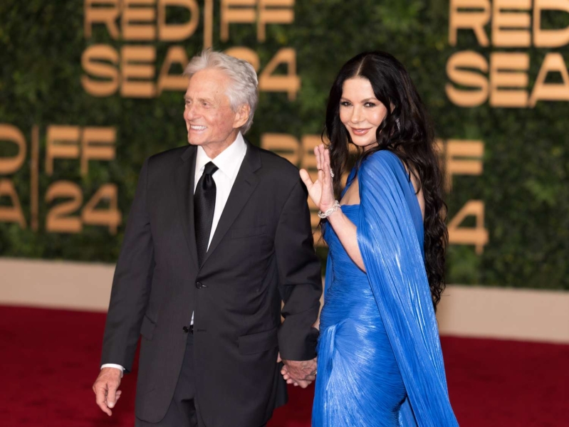 Catherine Zeta-Jones hopped aboard the witchy woman trend with her dramatic cobalt blue cape dress on a date night with Michael Douglas. See photos.