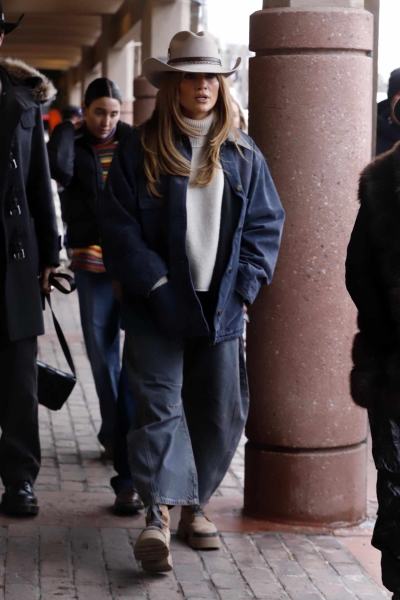 Jennifer Lopez was spotted out and about in Aspen wearing a beige feathered cowboy hat and a barn jacket in a rodeo chic look.