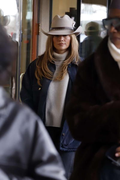 Jennifer Lopez was spotted out and about in Aspen wearing a beige feathered cowboy hat and a barn jacket in a rodeo chic look.