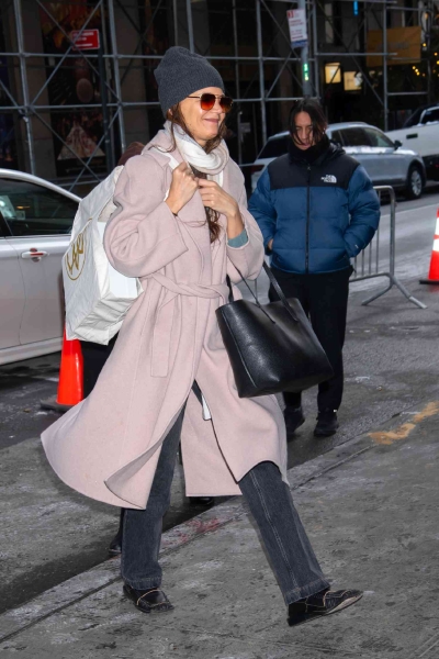 Katie Holmes was seen in New York City on December 21 in a cozy pink wrap coat. See the full outfit here.