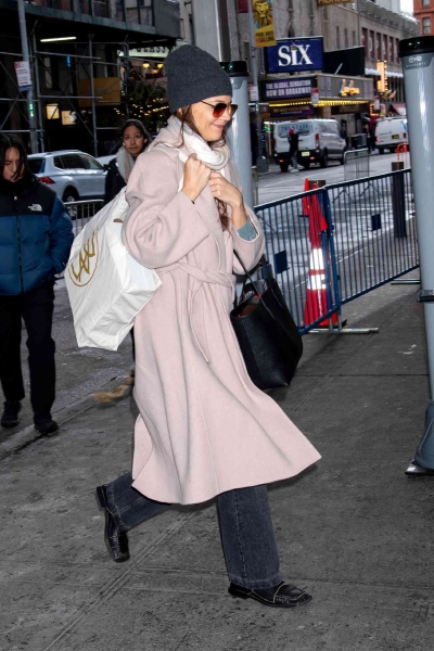 Katie Holmes was seen in New York City on December 21 in a cozy pink wrap coat. See the full outfit here.