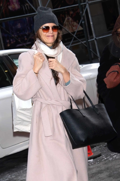 Katie Holmes was seen in New York City on December 21 in a cozy pink wrap coat. See the full outfit here.