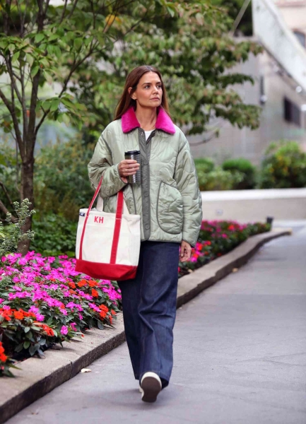 Katie Holmes wore an oversize black coat in New York City on December 1, 2024, and paired it with a white outfit underneath, breaking the rule of no white after Labor Day.