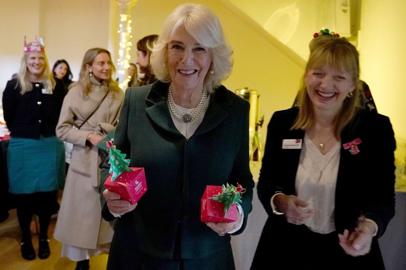 Queen Camilla attended a Christmas lunch in a festive suit and sentimental jewelry. See her holiday-ready look, here.