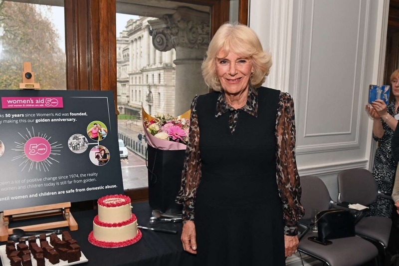 Queen Camilla attended a Christmas lunch in a festive suit and sentimental jewelry. See her holiday-ready look, here.