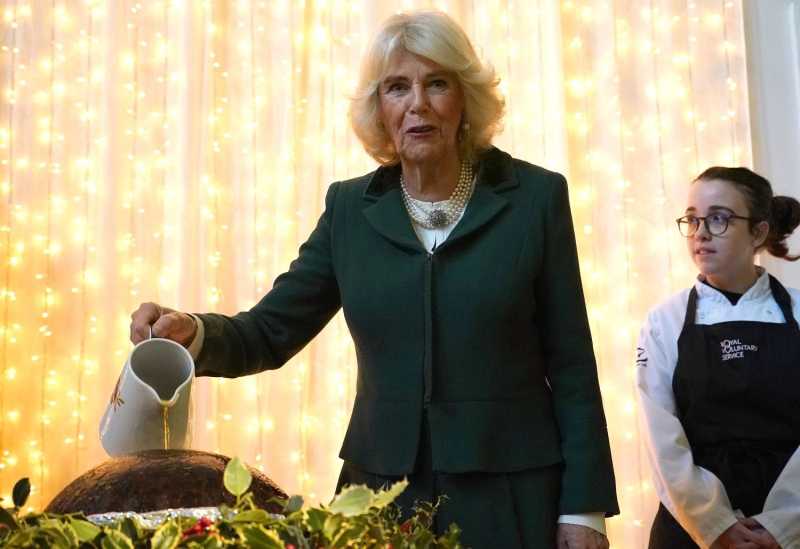 Queen Camilla attended a Christmas lunch in a festive suit and sentimental jewelry. See her holiday-ready look, here.