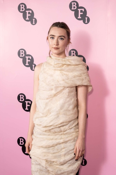 Saoirse Ronan appeared at a special event with three-time co-star Timothée Chalamet wearing a pale pink organza funnel dress by Khaite that looked as comfy as a sleeping bag.