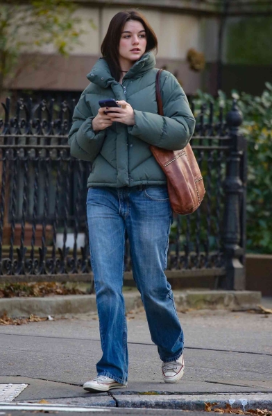 Suri Cruise was spotted in an outfit that looked like it came directly from Katie Holmes's closet. Cruise wore baggy jeans and a puffer jacket to see her mom's production of 'Our Town' on Broadway.